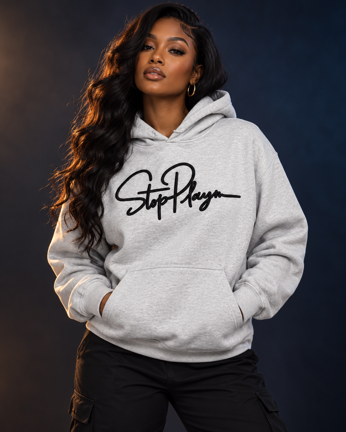 Adult model wearing the gray StopPlayn Signature Collection Hoodie with black embroidery